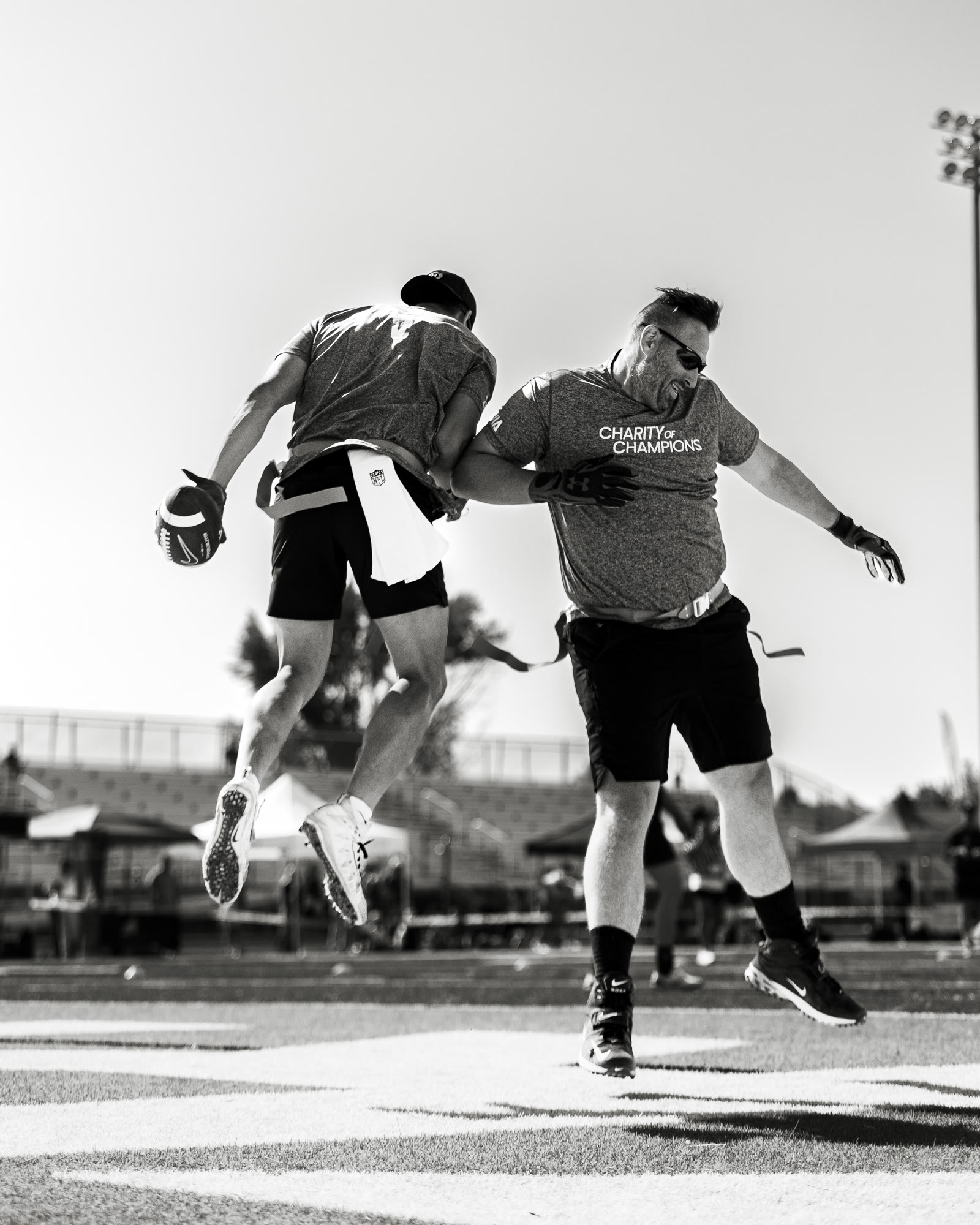 Mid-air chest bump celebration in black and white